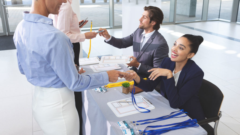 Conference and Meeting Staff handing out badges at registration